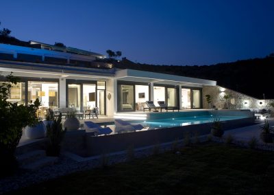 Luxury villa pool deck with loungers overlooking the Ionian horizon