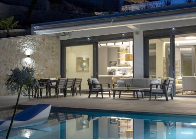 Luxury villa pool deck with loungers overlooking the Ionian horizon