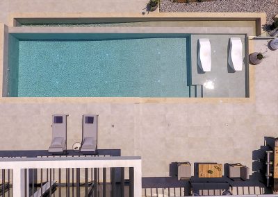 Luxury villa pool deck with loungers overlooking the Ionian horizon