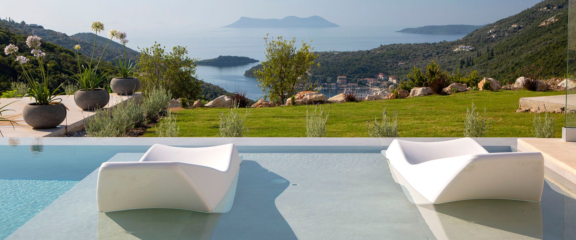 Private pool terrace in Nikiana villa with sweeping coastline views