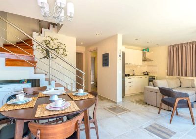 Elegant villa kitchen and dining space with modern island finishes