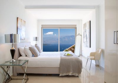 Refined bedroom with king-size bed and balcony access