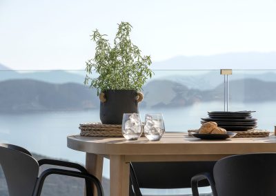 Elevated infinity pool terrace at Nikiana villa with panoramic coastline views