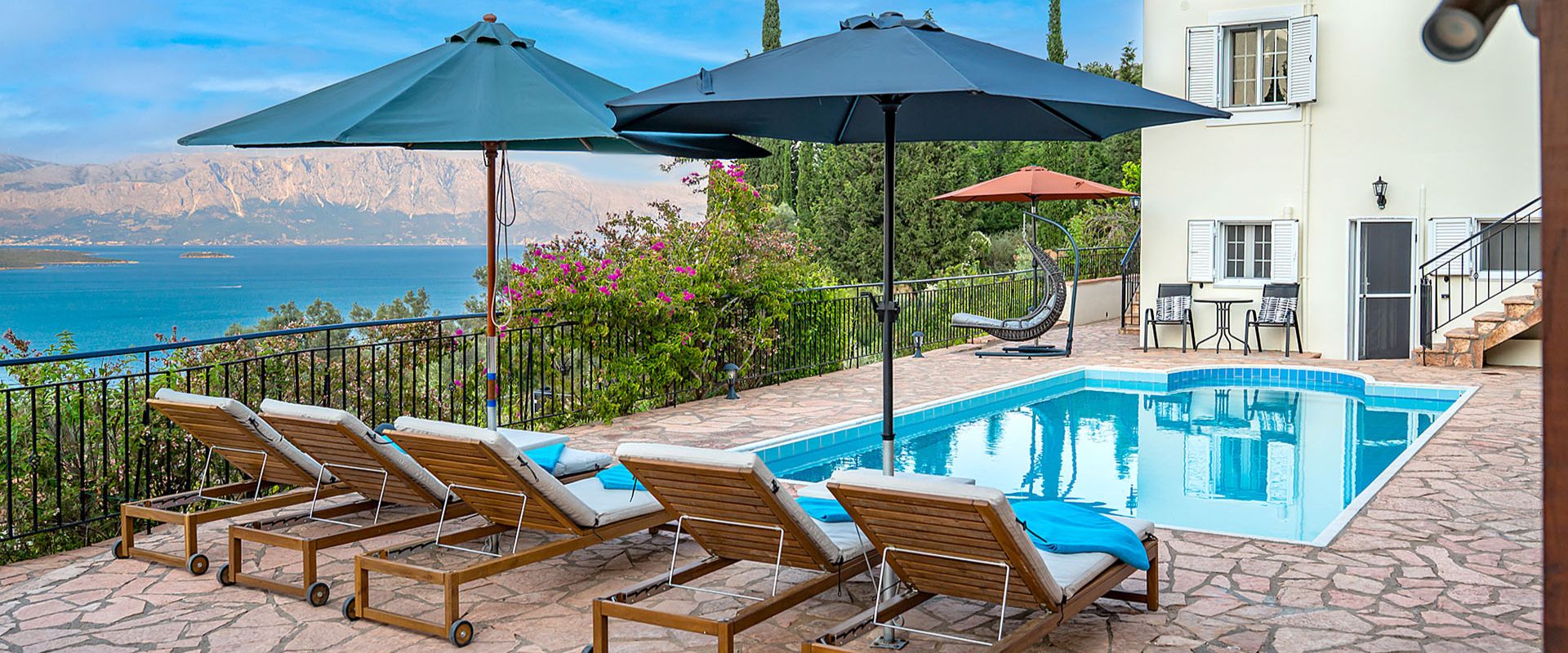 Private swimming pool with sun loungers and Ionian Sea backdrop