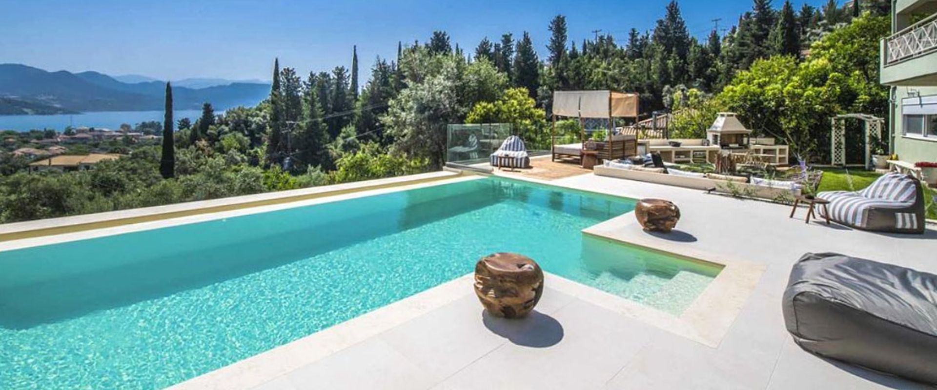 Private swimming pool with sun loungers and Ionian Sea backdrop
