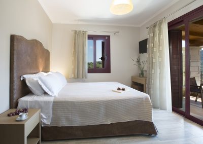 Spacious luxury bedroom suite with sea-facing balcony in Nikiana villa