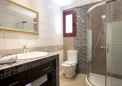 Spacious luxury bedroom suite with sea-facing balcony in Nikiana villa