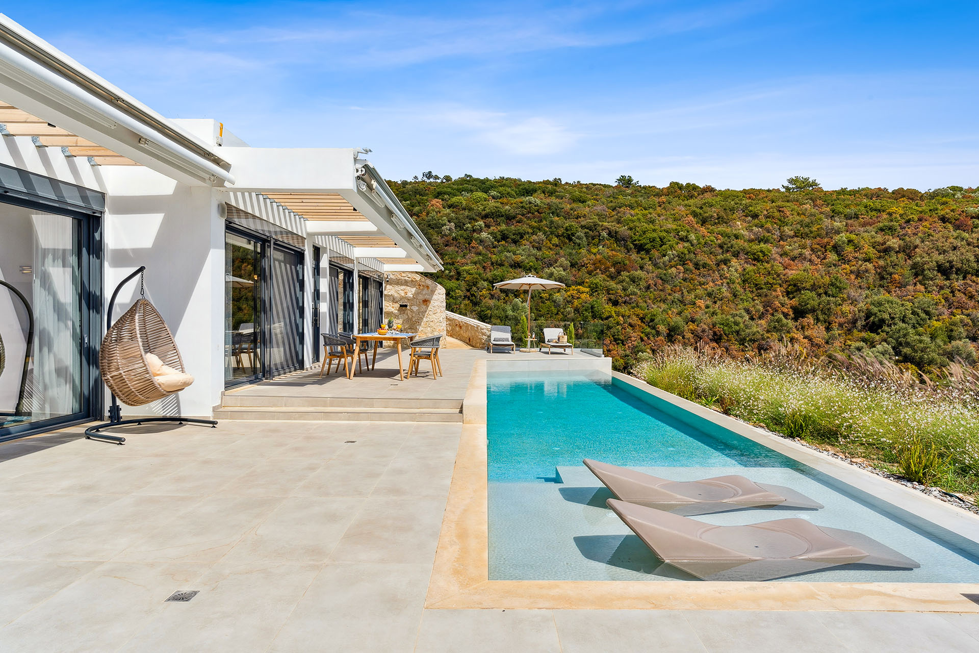Private pool deck with premium sun loungers in Ammousa