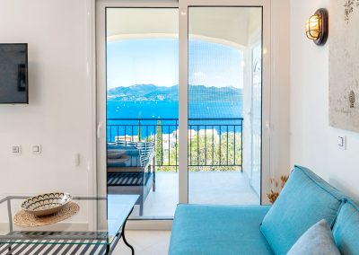 Open-plan living room with modern furnishings and sea views