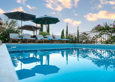 Private swimming pool with sun loungers and Ionian Sea backdrop