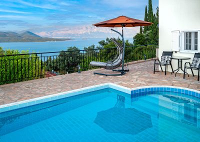Private swimming pool with sun loungers and Ionian Sea backdrop
