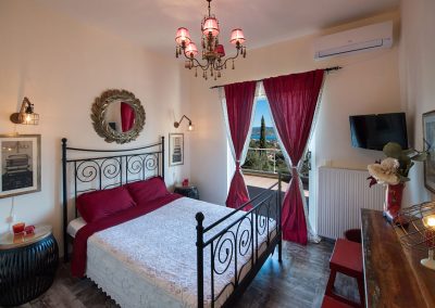 Stylish sea-facing bedroom interior in Sivota with boutique hotel aesthetics