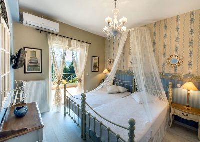 Stylish sea-facing bedroom interior in Sivota with boutique hotel aesthetics