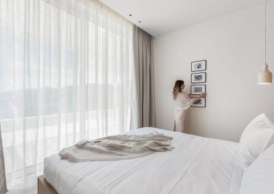 Contemporary bedroom at Villa Mia Rose with comfortable bedding and uninterrupted sea views in Lefkada