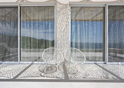 Villa Mia Rose outdoor area with spacious terrace, shaded seating, and breathtaking sea views in Amousa